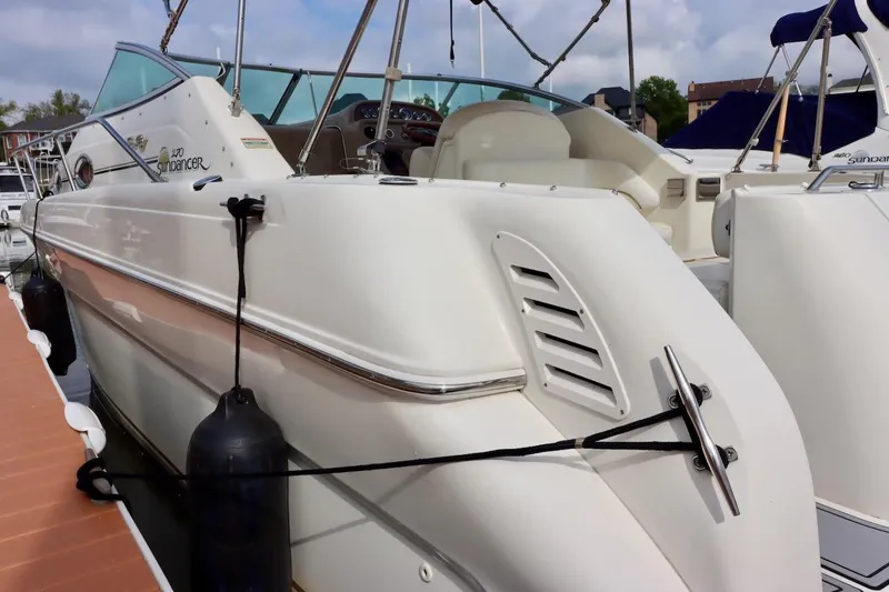 Slide: The Image of 2000 Sea Ray 270 Sundancer docked, showcasing sleek design and white exterior. - 5