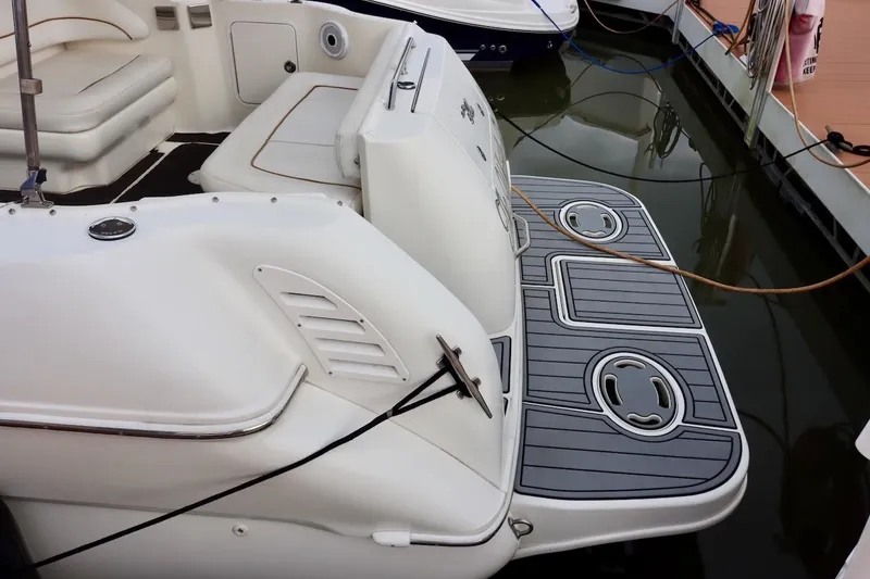 Slide: The Image of Rear view of 2000 Sea Ray 270 Sundancer boat docked, featuring swim platform. - 6