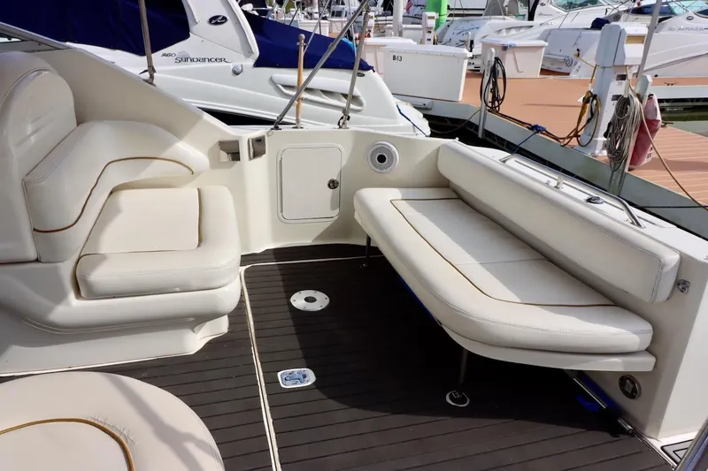 Slide: The Image of 2000 Sea Ray 270 Sundancer interior with white seating and sleek design. - 7