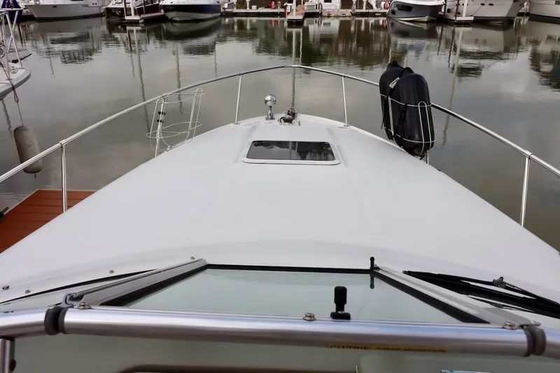 Slide: The Image of 2000 Sea Ray 270 Sundancer boat docked in a marina, view from the bow. - 9