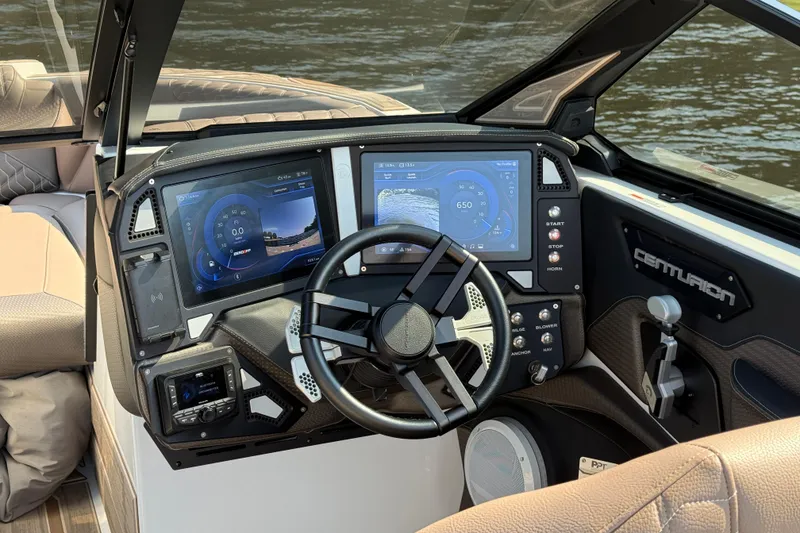 Slide: The Image of 2025 Centurion Ri245 boat dashboard with advanced digital displays and controls. - 11