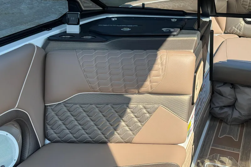 Slide: The Image of 2025 Centurion Ri245 boat interior with luxurious tan seating and modern design. - 13