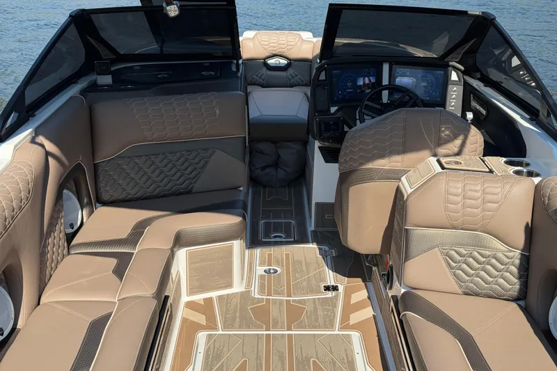 Slide: The Image of 2025 Centurion Ri245 boat interior with luxurious seating and modern dashboard design. - 20