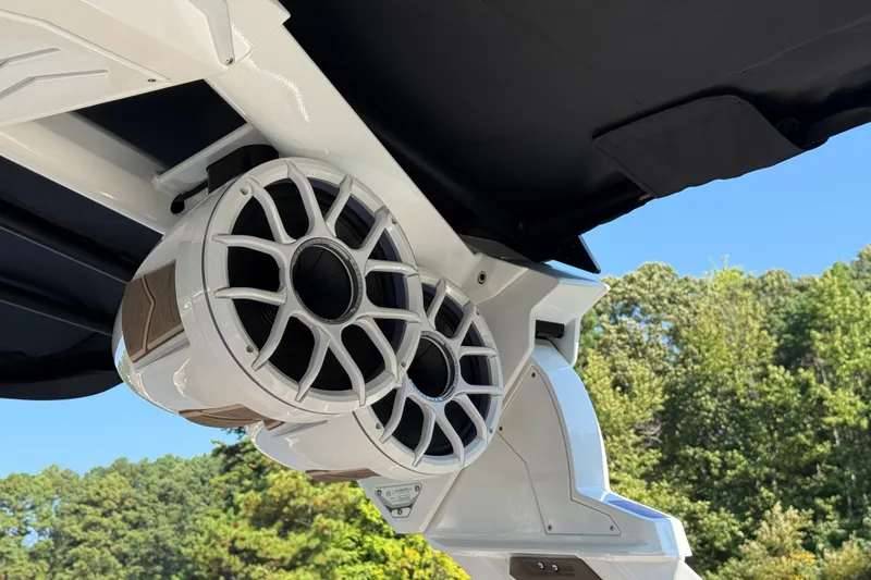 Slide: The Image of 2025 Centurion Ri245 boat speakers under canopy, surrounded by trees and blue sky. - 21