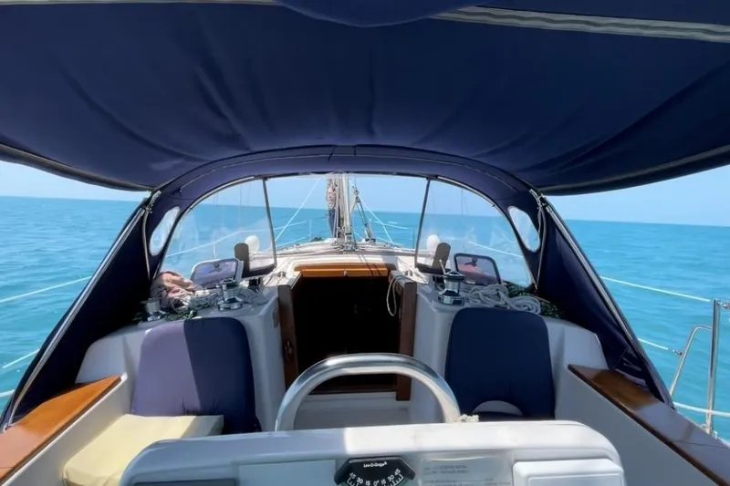 Slide: The Image of Cockpit view of a 1997 Island Packet 37 sailboat on open sea. - 2