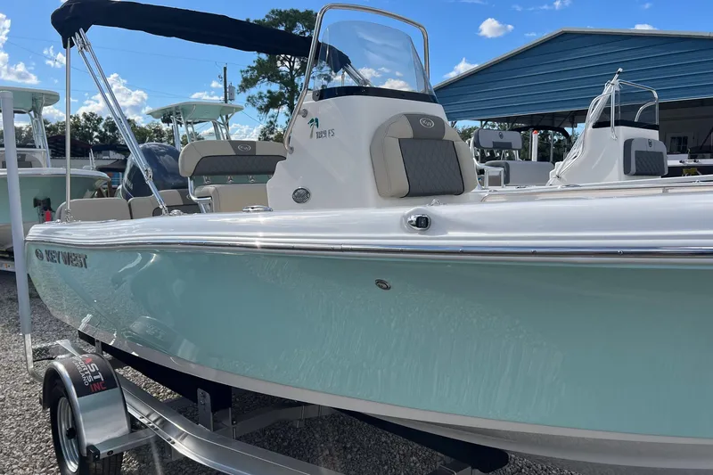 Slide: The Image of 2026 Key West 189 FS boat on trailer, displayed outdoors under blue sky. - 2