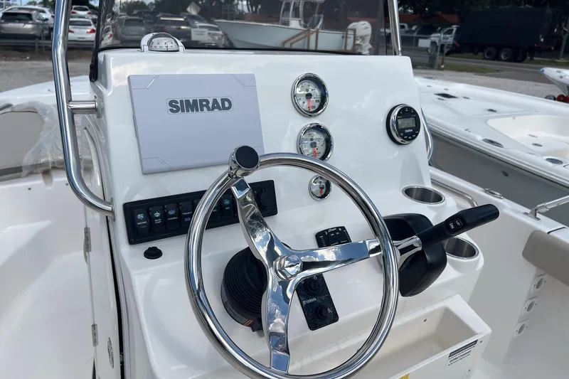 Slide: The Image of Steering console of 2026 Key West 189 FS boat with Simrad display and gauges. - 8