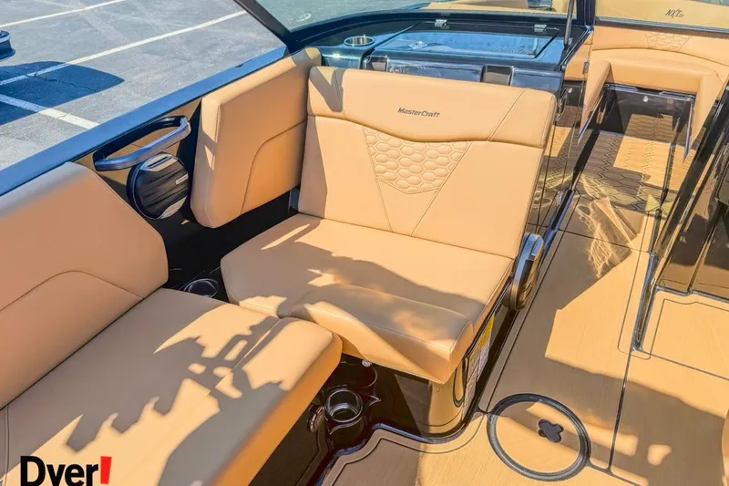 Slide: The Image of 2026 MasterCraft NXT23 boat interior with tan seating and modern design. - 11
