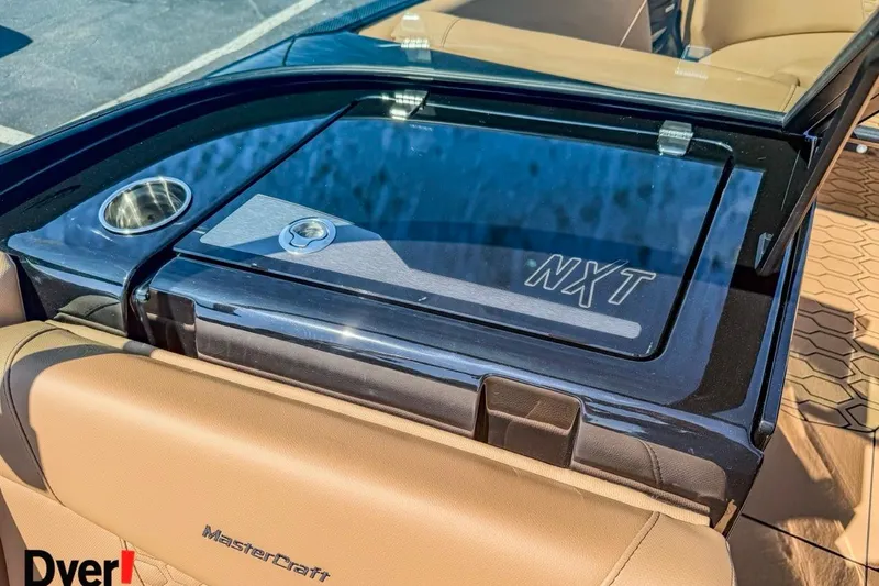 Slide: The Image of 2026 MasterCraft NXT23 boat interior with sleek design and cup holder. - 12
