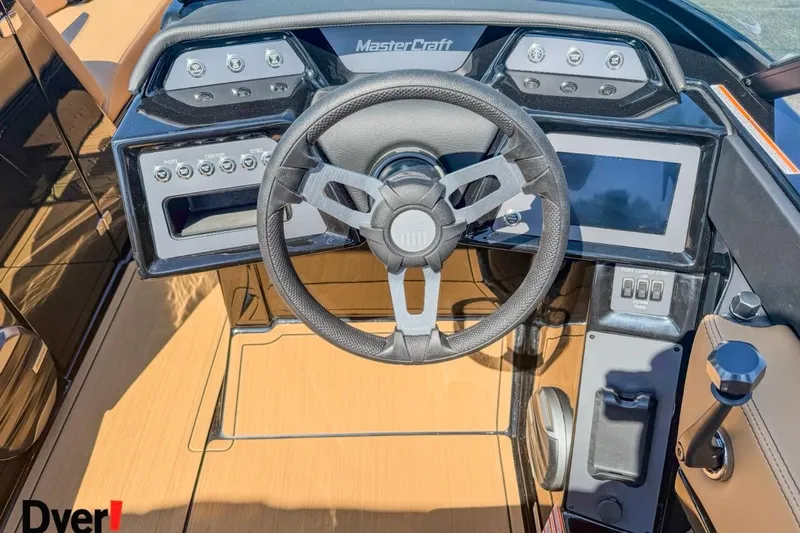 Slide: The Image of 2026 MasterCraft NXT23 boat dashboard with steering wheel and control panel. - 13