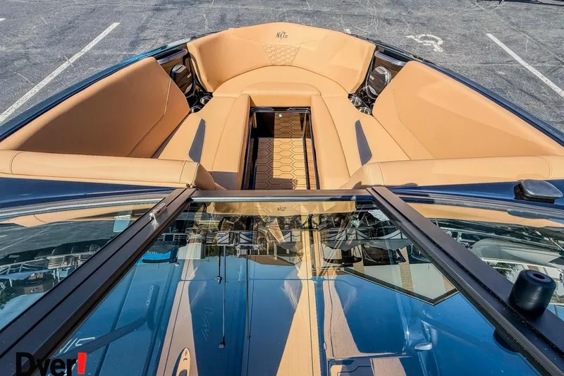 Slide: The Image of 2026 MasterCraft NXT23 boat interior with tan seating and sleek design. - 14