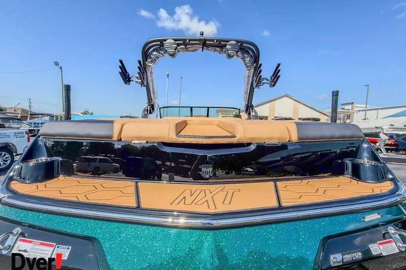 Slide: The Image of 2026 MasterCraft NXT23 boat, rear view, featuring tan seating and teal exterior. - 3