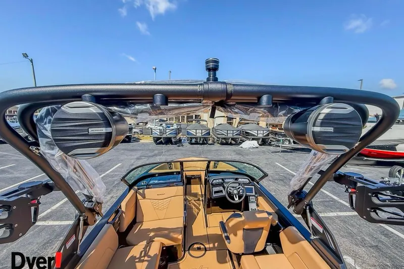 Slide: The Image of 2026 MasterCraft NXT23 boat interior with speakers and dashboard, parked outdoors. - 5