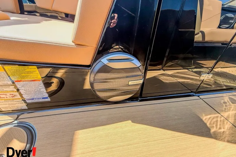 Slide: The Image of 2026 MasterCraft NXT23 boat interior with Meridian speaker and safety labels. - 9