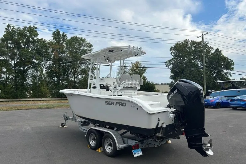 Slide: The Image of 2019 Sea Pro 219 boat on trailer, parked outdoors under a partly cloudy sky. - 1