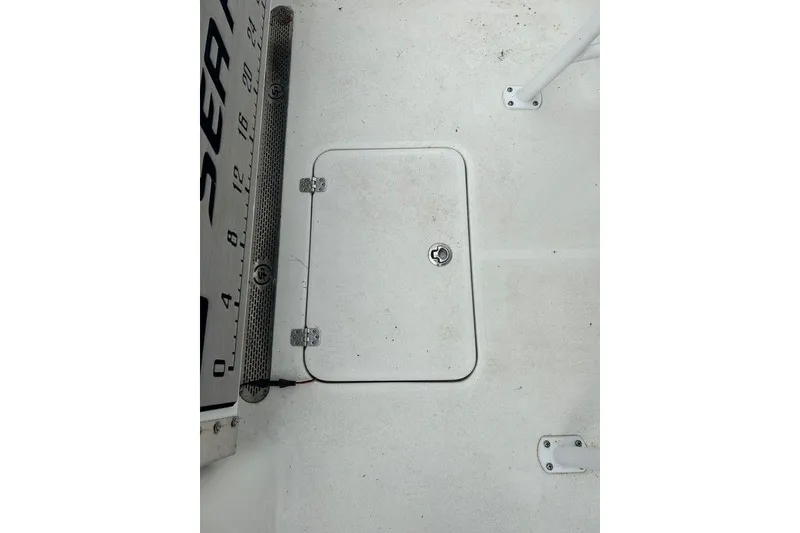 Slide: The Image of 2019 Sea Pro 219 boat deck with hatch and measuring ruler. - 13