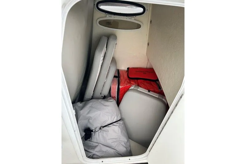 Slide: The Image of Storage compartment of 2019 Sea Pro 219 boat with cushions and safety gear. - 16