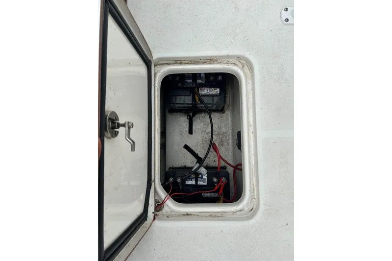 Slide: The Image of 2019 Sea Pro 219 boat battery compartment with wiring and open hatch. - 17