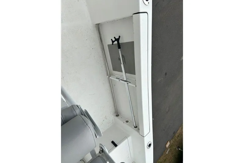 Slide: The Image of 2019 Sea Pro 219 boat interior storage compartment with rod holder. - 18
