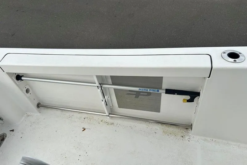 Slide: The Image of 2019 Sea Pro 219 boat interior with rod holder and storage compartment. - 19