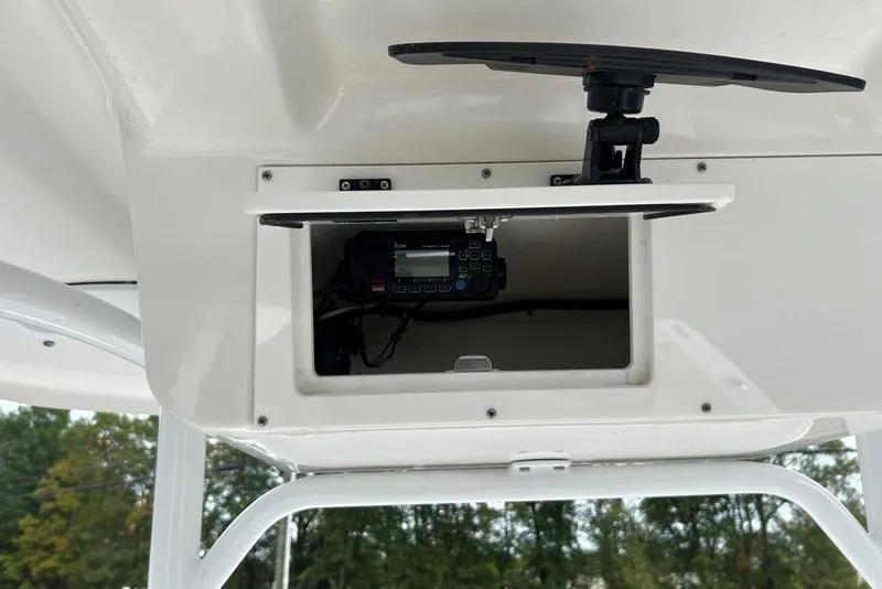 Slide: The Image of 2019 Sea Pro 219 boat console with open storage compartment and electronic equipment. - 22