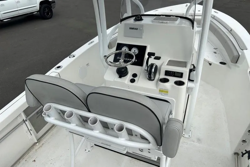 Slide: The Image of 2019 Sea Pro 219 boat helm with dual seats, steering wheel, and control panel. - 25