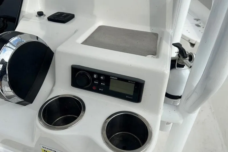 Slide: The Image of 2019 Sea Pro 219 boat console with stereo, cup holders, and fire extinguisher. - 26