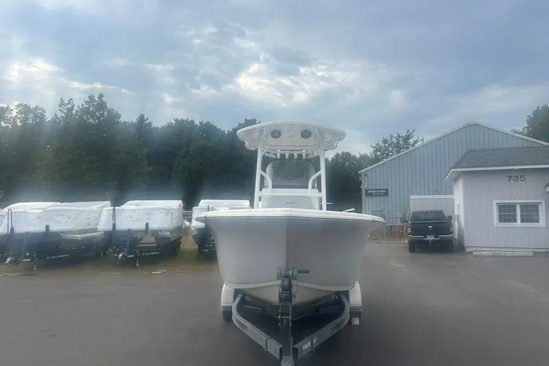 Slide: The Image of 2019 Sea Pro 219 boat on trailer, parked near buildings and covered boats. - 3