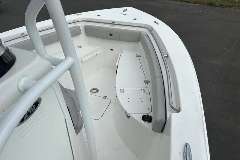 Slide: The Image of 2019 Sea Pro 219 boat interior with cushioned seating and storage compartments. - 30