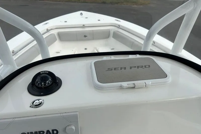 Slide: The Image of 2019 Sea Pro 219 boat dashboard with compass and storage compartment. - 31