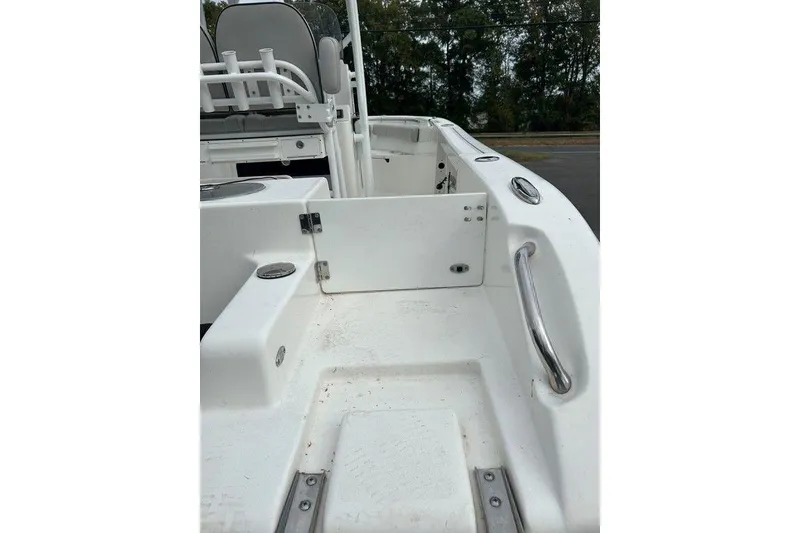 Slide: The Image of 2019 Sea Pro 219 boat interior with white seating and stainless steel handrails. - 5
