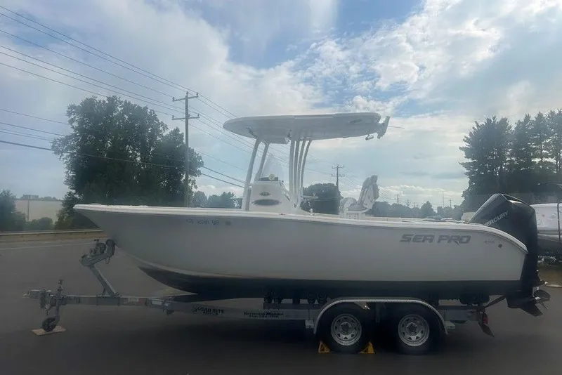 Slide: The Image of 2019 Sea Pro 219 boat on trailer under cloudy sky. - 7