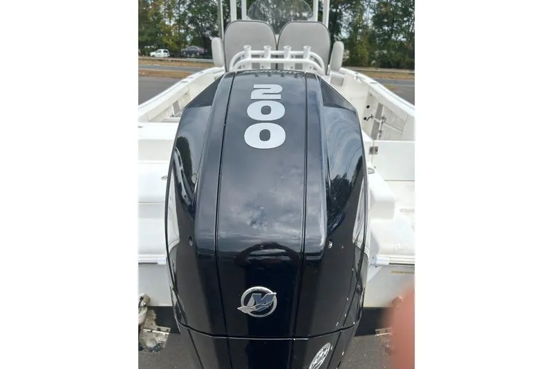 Slide: The Image of 2019 Sea Pro 219 boat with a 200 horsepower outboard motor, parked outdoors. - 8