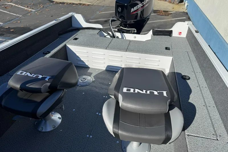 Slide: The Image of 2026 Lund 1650 Angler SS boat interior with two seats and a Mercury engine. - 10