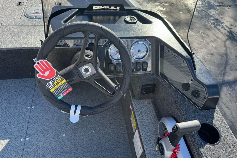 Slide: The Image of 2026 Lund 1650 Angler SS boat dashboard with steering wheel and gauges. - 12
