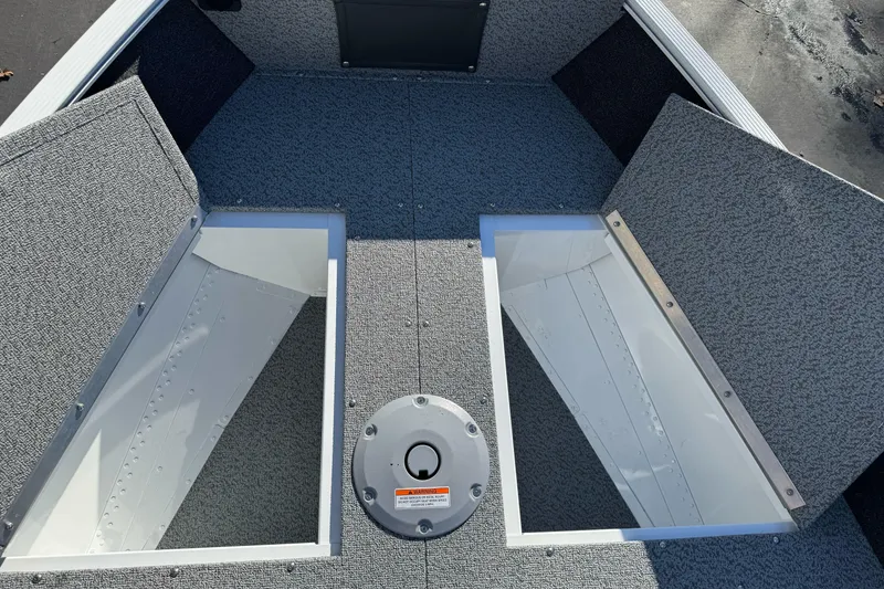 Slide: The Image of 2026 Lund 1650 Angler SS boat interior with open storage compartments. - 14