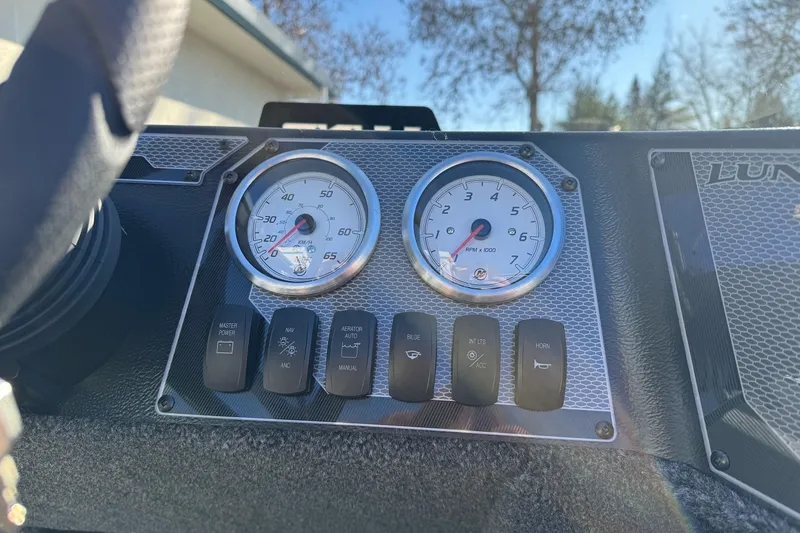 Slide: The Image of Dashboard of 2026 Lund 1650 Angler SS boat with gauges and control switches. - 18