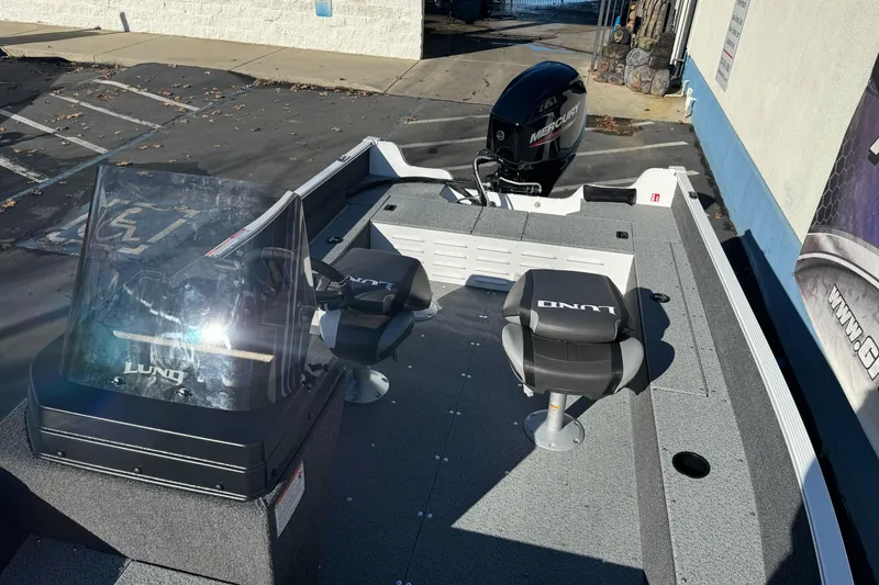 Slide: The Image of 2026 Lund 1650 Angler SS boat with Mercury engine, featuring dual seats and windshield. - 9