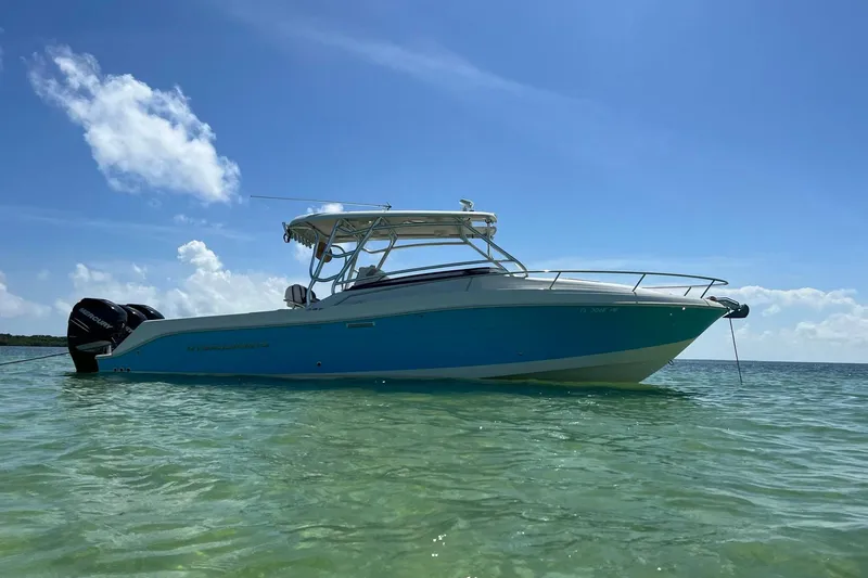 The Image of 2008 Hydra-Sports Vector 3300 VX boat docked at marina, featuring sleek design and blue accents. - 0