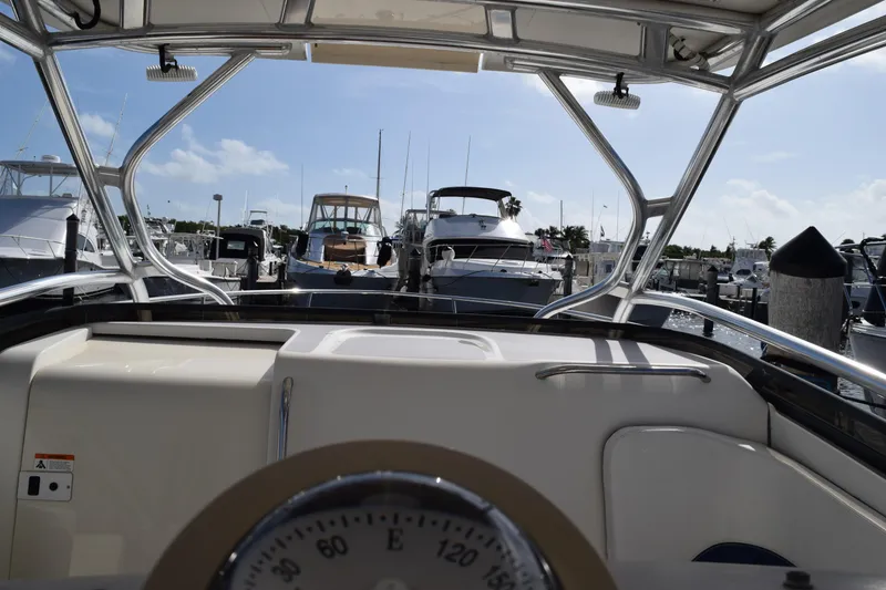 Slide: The Image of 2008 Hydra-Sports Vector 3300 VX docked at marina, showcasing sleek design and spacious deck. - 161