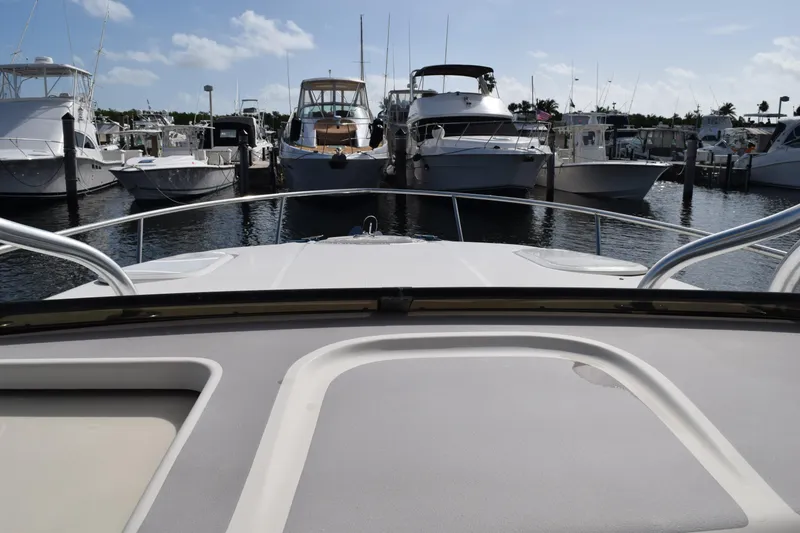 Slide: The Image of 2008 Hydra-Sports Vector 3300 VX boat detail with "GUEST" label, under blue sky. - 181