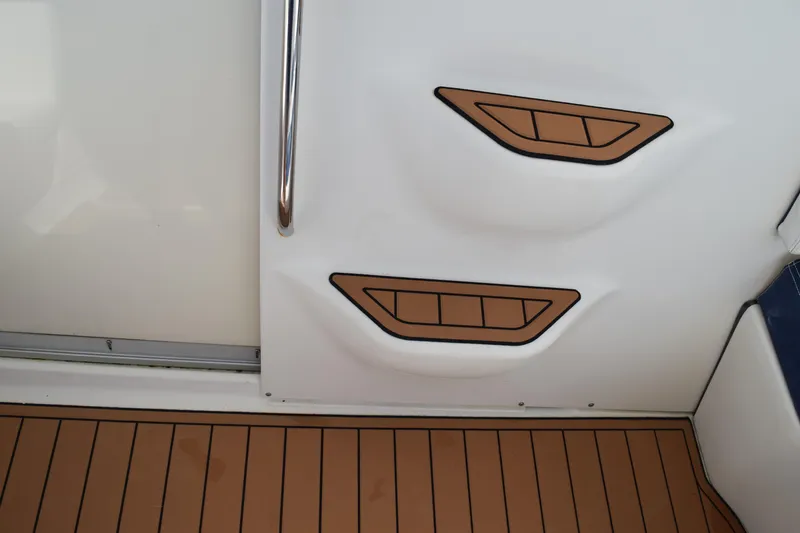 Slide: The Image of 2008 Hydra-Sports Vector 3300 VX boat docked, featuring sleek design and stainless steel railings. - 184