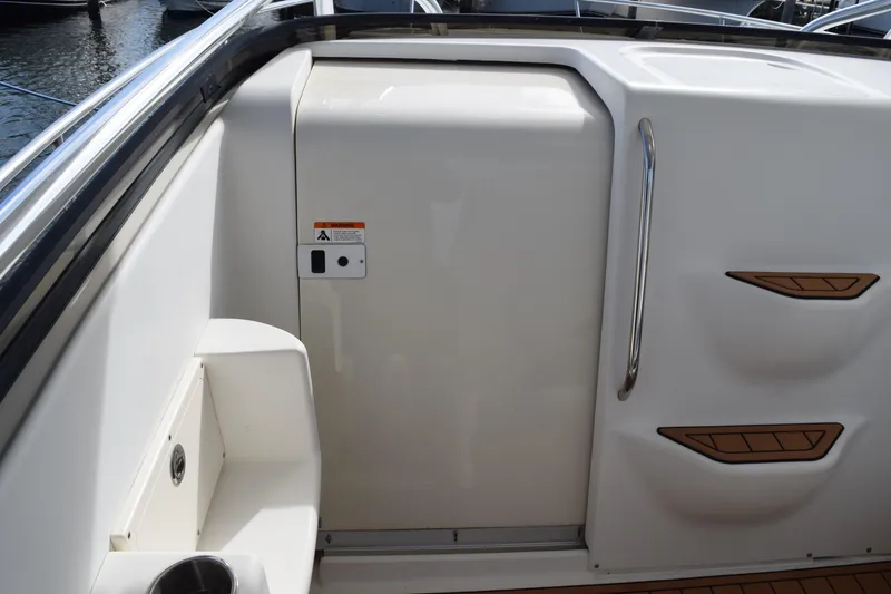 Slide: The Image of 2008 Hydra-Sports Vector 3300 VX boat deck with teak flooring and metal fixtures. - 187