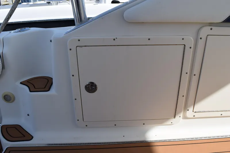 Slide: The Image of 2008 Hydra-Sports Vector 3300 VX boat deck with wood finish and storage compartments. - 74