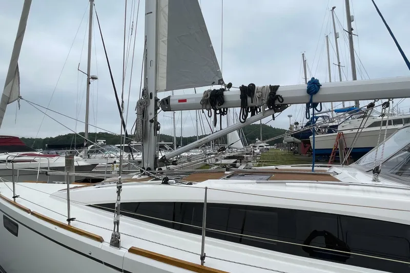 Slide: The Image of Sailboat Bavaria Vision 42, 2013 model, docked in a marina with other boats. - 11