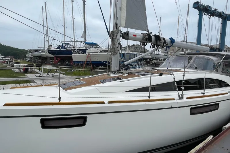 Slide: The Image of 2013 Bavaria Vision 42 sailboat docked at a marina, surrounded by other vessels. - 14