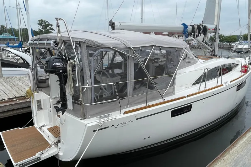 Slide: The Image of 2013 Bavaria Vision 42 sailboat docked with canopy and outboard motor. - 17