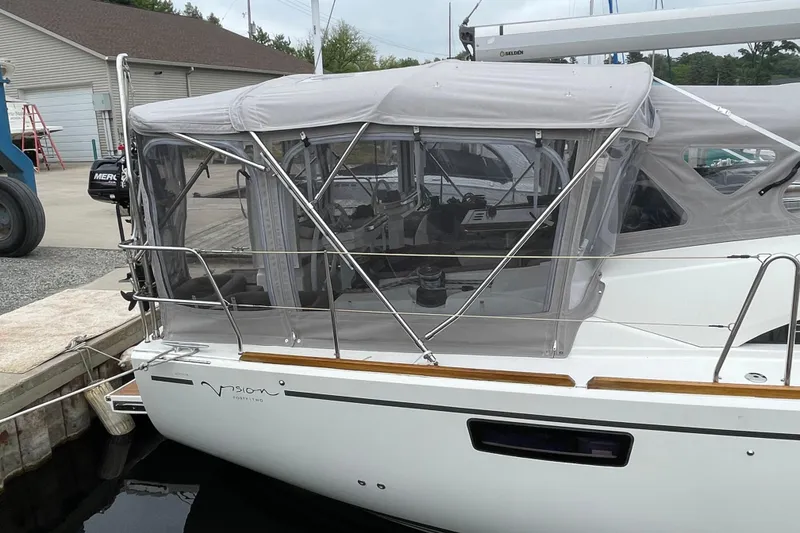 Slide: The Image of 2013 Bavaria Vision 42 sailboat with covered cockpit, docked at a marina. - 18