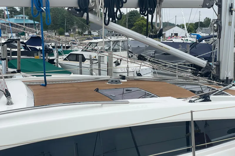 Slide: The Image of Sailboat Bavaria Vision 42, 2013 model, docked at marina with wooden deck and rigging. - 20
