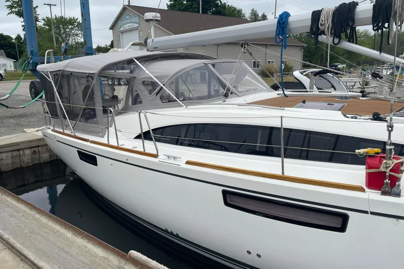 Slide: The Image of 2013 Bavaria Vision 42 yacht docked at marina, featuring sleek design and covered cockpit. - 23